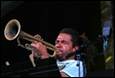 A person playing a trumpet

Description automatically generated