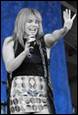 A person holding a microphone

Description automatically generated with medium confidence