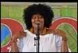 A person singing into a microphone

Description automatically generated