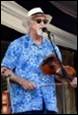 A person wearing a hat and sunglasses playing a violin

Description automatically generated with low confidence
