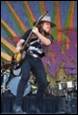 A person playing a guitar on stage

Description automatically generated with medium confidence