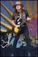 A person playing a guitar on a stage

Description automatically generated with medium confidence
