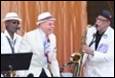 A group of men playing instruments

Description automatically generated with medium confidence