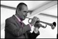 A person playing a trumpet

Description automatically generated