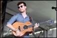 A person holding a guitar

Description automatically generated with medium confidence