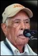 A picture containing person, human face, microphone, clothing

Description automatically generated