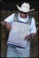 A person wearing a cowboy hat and white shirt

Description automatically generated with medium confidence