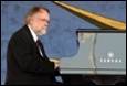 A person playing a piano

Description automatically generated with medium confidence