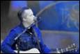 A person playing guitar and singing

Description automatically generated with low confidence