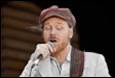 A person singing into a microphone

Description automatically generated