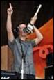 A picture containing person, concert, microphone, clothing

Description automatically generated