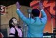 A person in a blue suit raising his hands

Description automatically generated with low confidence
