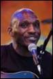 A person with a microphone

Description automatically generated with medium confidence