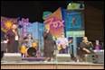 A group of people on a stage

Description automatically generated