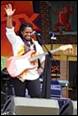 A person holding a guitar and raising her hand

Description automatically generated with low confidence