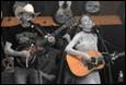 A group of people playing instruments

Description automatically generated