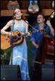 A person and person playing guitar

Description automatically generated