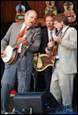 A group of men playing instruments

Description automatically generated