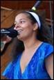A person singing into a microphone

Description automatically generated