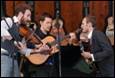 A group of men playing instruments

Description automatically generated