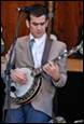 A person playing a banjo

Description automatically generated