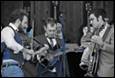 A group of men playing instruments

Description automatically generated