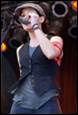 A person singing on stage

Description automatically generated