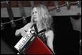 A person playing an accordion

Description automatically generated