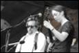 A person and person playing instruments

Description automatically generated