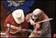 A group of people playing instruments

Description automatically generated