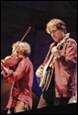 A couple of men playing instruments

Description automatically generated
