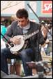A person playing a banjo

Description automatically generated