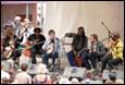 A group of people playing instruments

Description automatically generated