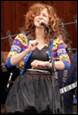 A person singing into a microphone

Description automatically generated