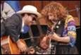 A group of people playing instruments

Description automatically generated
