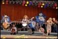 A group of people playing instruments on a stage

Description automatically generated