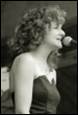 A person singing into a microphone

Description automatically generated