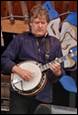 A person playing a banjo

Description automatically generated