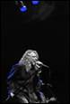 A person singing into a microphone

Description automatically generated