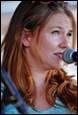 A person speaking into a microphone

Description automatically generated