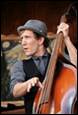 A person playing a bass

Description automatically generated