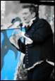 A person in a suit speaking into a microphone

Description automatically generated