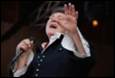 A person singing into a microphone

Description automatically generated