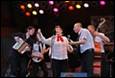 A group of people performing on stage

Description automatically generated