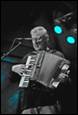 A person playing an accordion

Description automatically generated