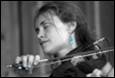 A person holding a violin

Description automatically generated
