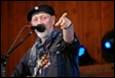 A person with a microphone pointing at something

Description automatically generated