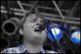 A person singing into a microphone

Description automatically generated