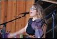 A person singing into a microphone

Description automatically generated