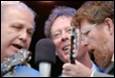 A group of men singing into a microphone

Description automatically generated